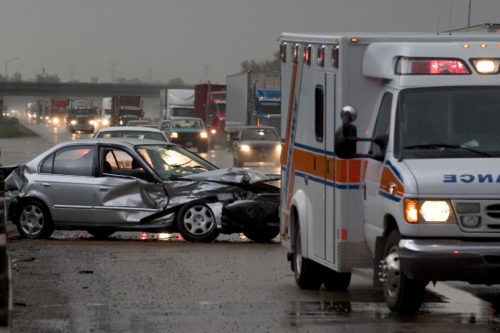 Car accident on highway with ambulance in front